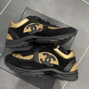 CHANEL Black and Gold CC Emblem low top trainer Sneakers